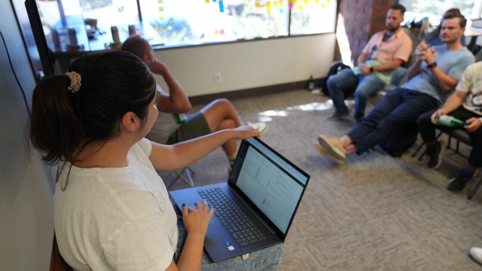 Marketing team reviewing contact data on a laptop