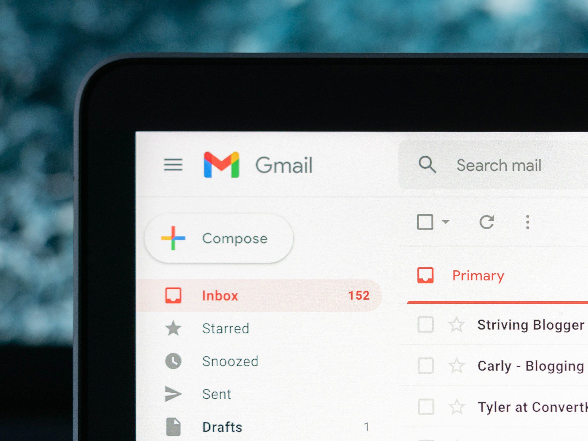 Checking a Gmail inbox on a laptop at a desk